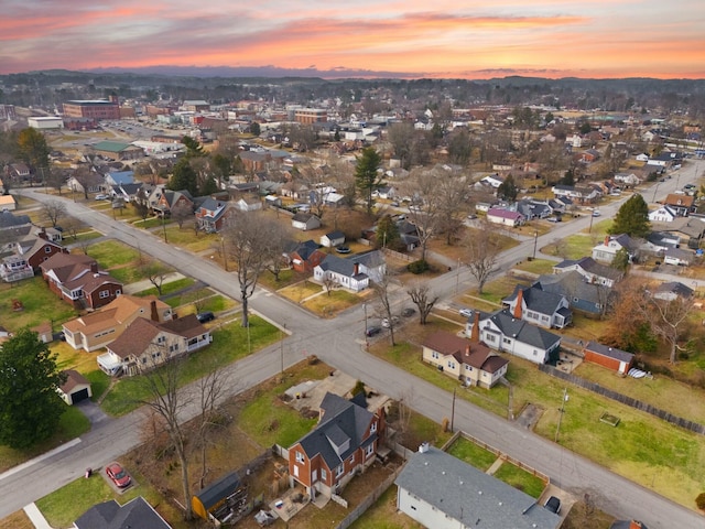 aerial view at dusk featuring a residential view