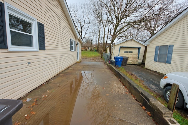 view of property exterior with an outbuilding and a garage