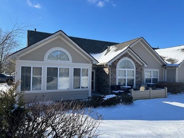 view of snow covered rear of property