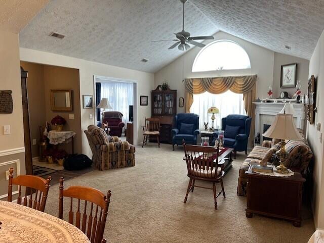 carpeted living room featuring vaulted ceiling, plenty of natural light, and a textured ceiling