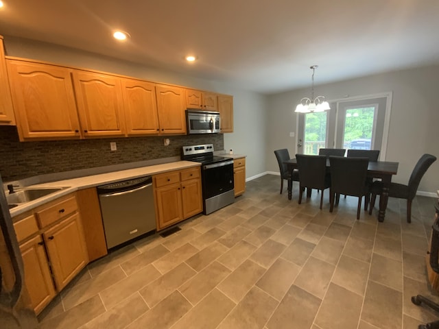 251 A Duncan Rd, Strunk, KY 42649 - kitchen featuring stainless steel appliances, decorative backsplash, a chandelier, hanging light fixtures, and recessed lighting