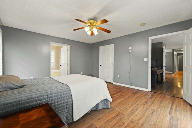 251 A Duncan Rd, Strunk, KY 42649 - bedroom featuring wood finished floors, a textured ceiling, a ceiling fan, and ensuite bath