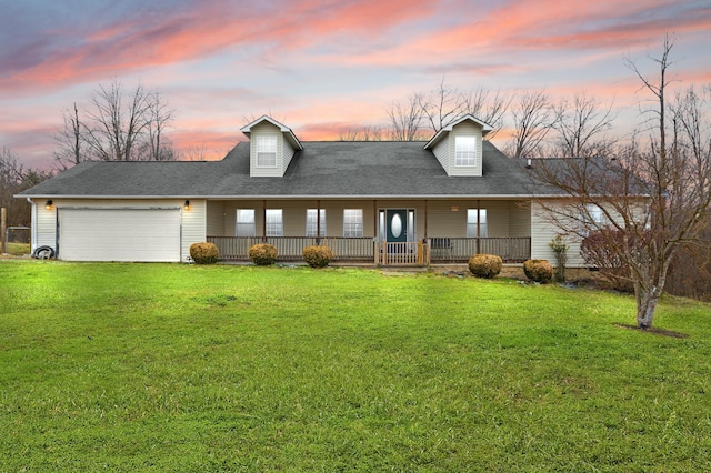 cape cod house with a garage, covered porch, and a lawn