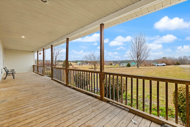 wooden deck featuring a lawn