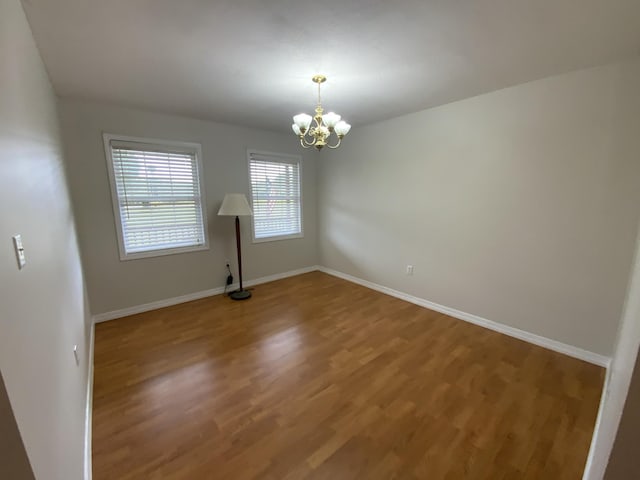 251 A Duncan Rd, Strunk, KY 42649 - empty room with a chandelier and wood finished floors