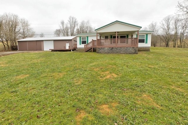 rear view of property featuring a wooden deck and a lawn