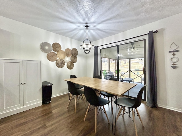 dining space with dark wood-type flooring, an inviting chandelier, and a textured ceiling