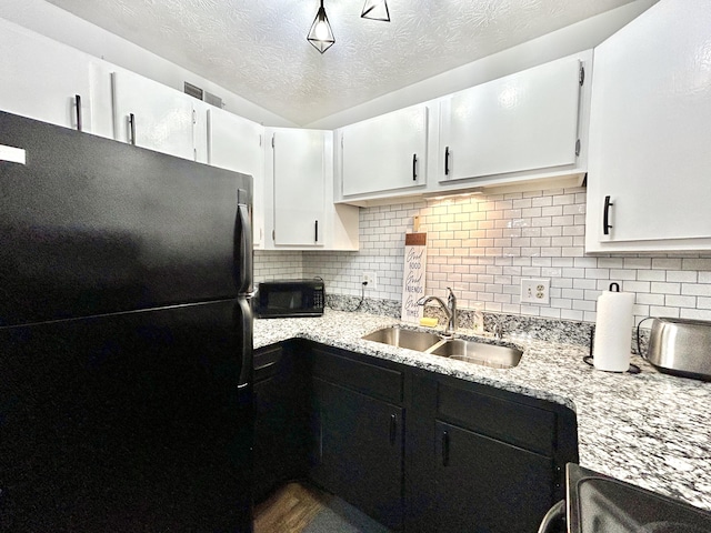 kitchen featuring white cabinets, sink, decorative backsplash, and black appliances