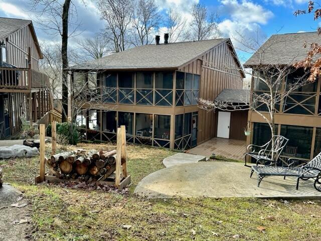 back of property featuring a sunroom and a patio