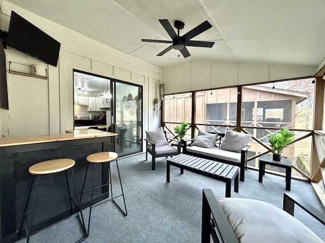 sunroom / solarium featuring lofted ceiling and ceiling fan