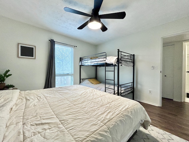 bedroom featuring hardwood / wood-style flooring, ceiling fan, and a textured ceiling