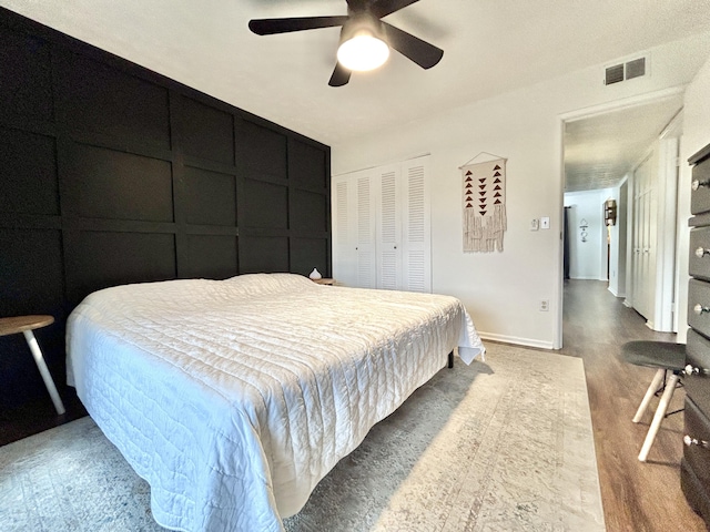 bedroom with ceiling fan, hardwood / wood-style floors, and a closet