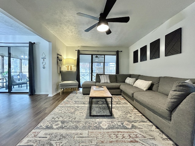 living room featuring hardwood / wood-style floors, a textured ceiling, and ceiling fan