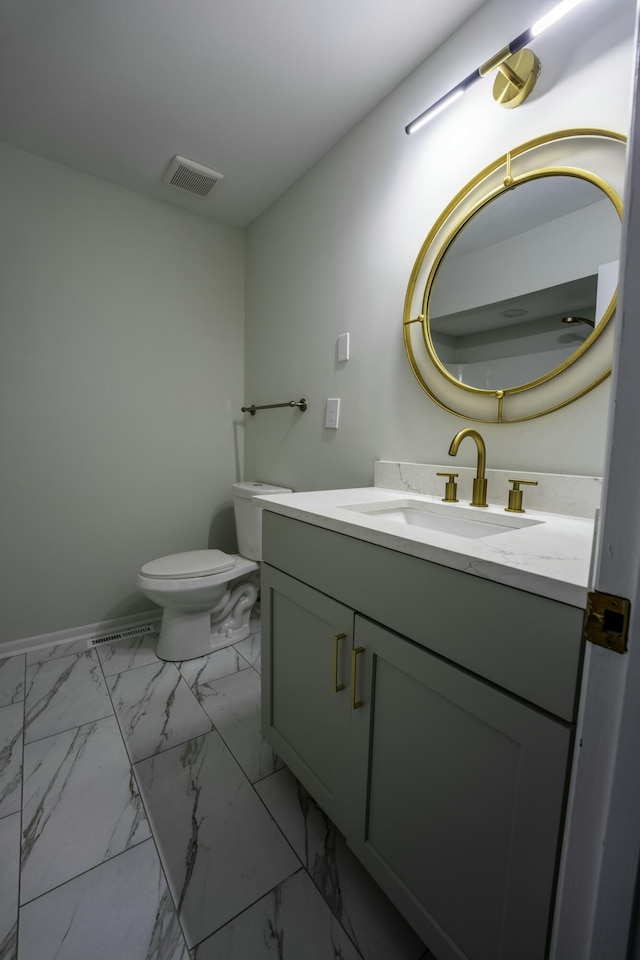 half bath with toilet, marble finish floor, visible vents, and vanity