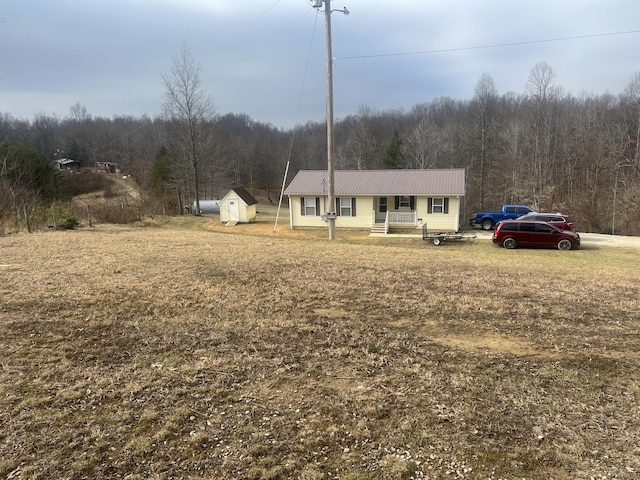 view of front of property featuring a shed