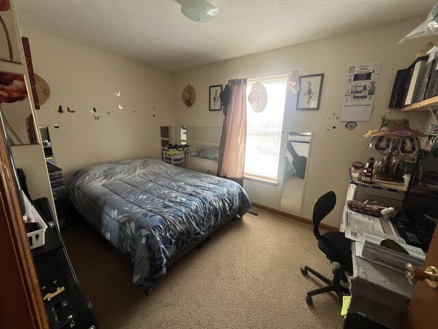 carpeted bedroom with a textured ceiling