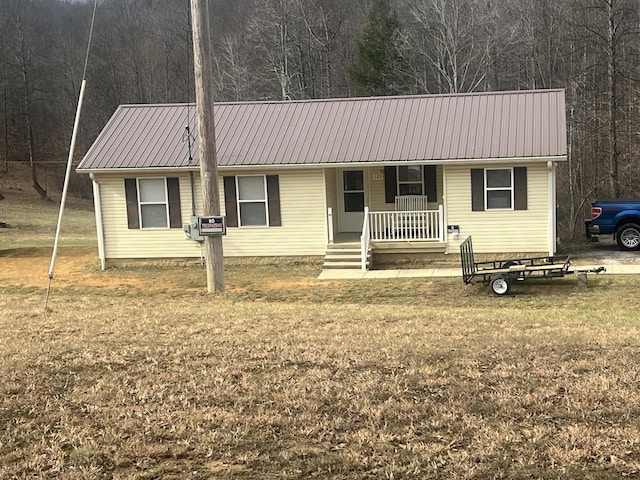 single story home with a porch and a front yard