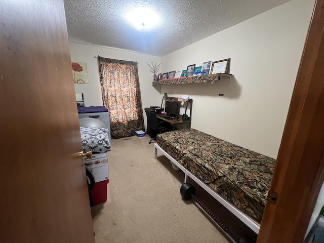 bedroom with washer / clothes dryer, carpet, and a textured ceiling