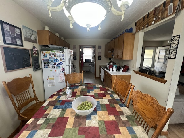 dining area with a healthy amount of sunlight and a textured ceiling