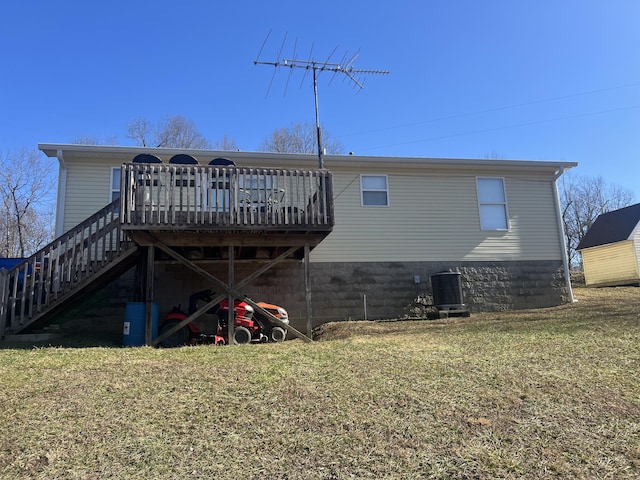 back of property featuring cooling unit, a deck, and a lawn