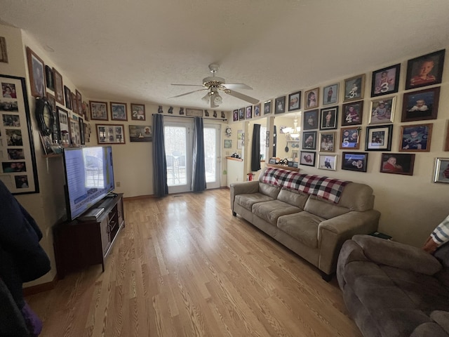 living room with ceiling fan and light wood-type flooring