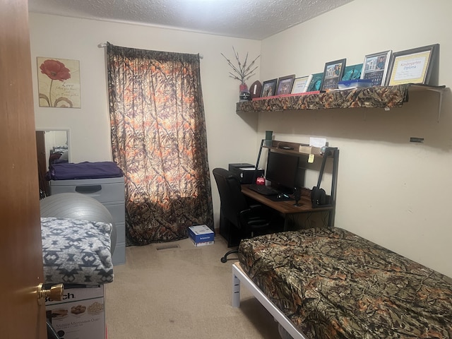 bedroom featuring washer / dryer, carpet floors, and a textured ceiling