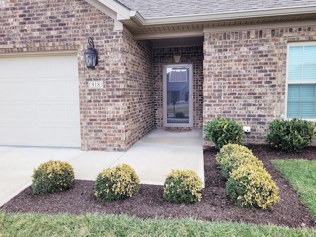 view of exterior entry with a garage