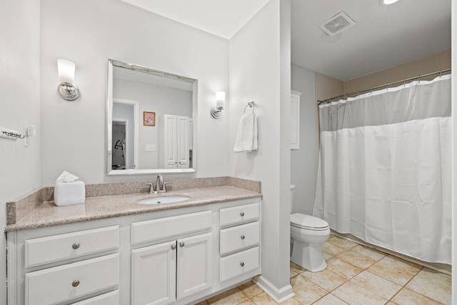 bathroom with tile patterned floors, vanity, and toilet