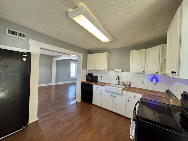 kitchen featuring sink, wooden counters, black appliances, white cabinets, and dark hardwood / wood-style flooring