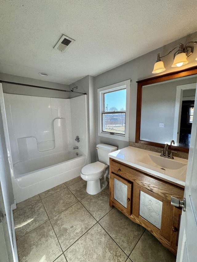 full bathroom with toilet, bathing tub / shower combination, a textured ceiling, vanity, and tile patterned flooring