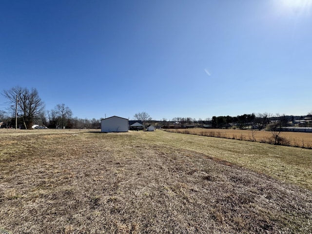 view of yard with a rural view