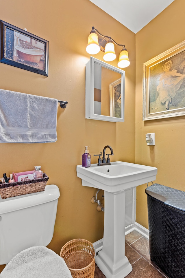 bathroom featuring sink, tile patterned floors, and toilet