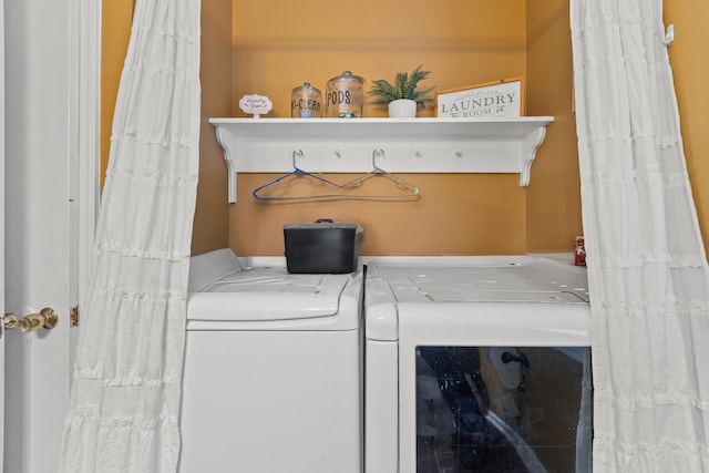 clothes washing area with washer and dryer