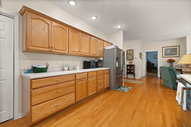 kitchen featuring high quality fridge and light wood-type flooring