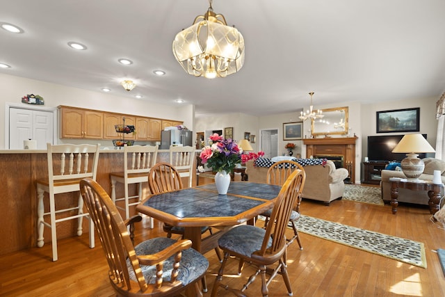 dining room with an inviting chandelier and light wood-type flooring