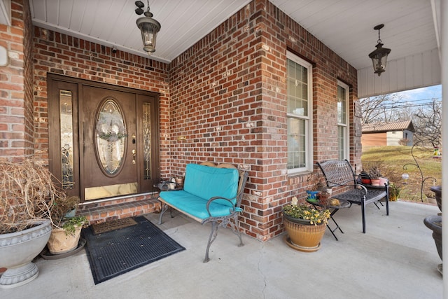 view of exterior entry with covered porch