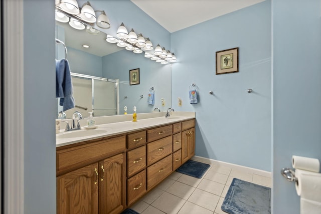 bathroom with vanity, a shower with shower door, and tile patterned flooring