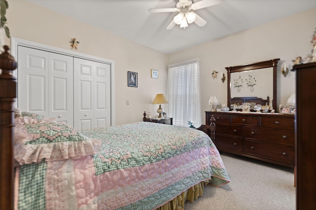 carpeted bedroom with ceiling fan and a closet