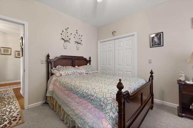 bedroom featuring light colored carpet and a closet