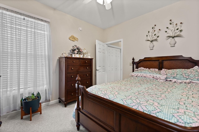 carpeted bedroom featuring multiple windows and ceiling fan