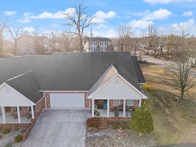 view of front facade with a garage, a front yard, and covered porch