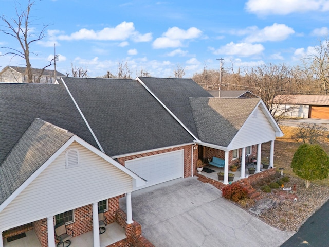 ranch-style house with a garage and covered porch