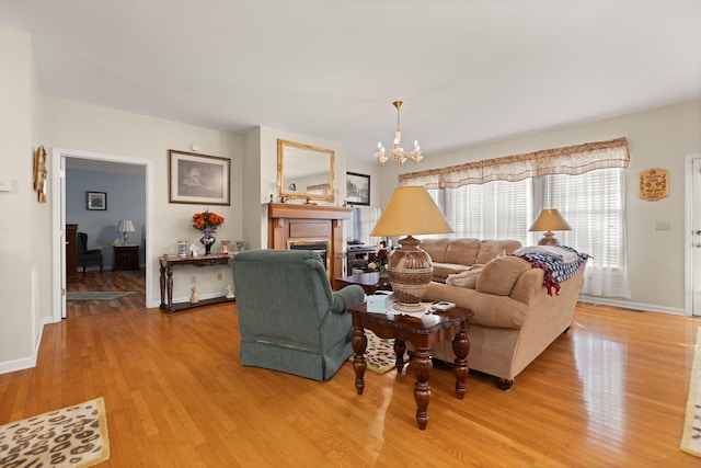living room featuring an inviting chandelier and light hardwood / wood-style floors