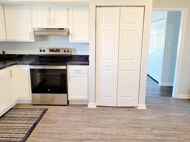 kitchen featuring electric range, white cabinets, and light wood-type flooring