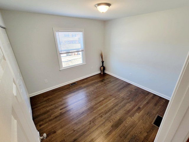 spare room featuring dark hardwood / wood-style floors