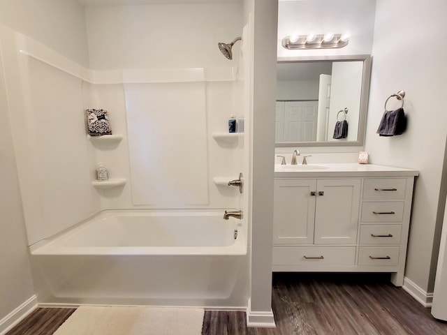 bathroom featuring vanity, wood-type flooring, and shower / bath combination