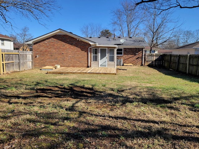 back of house with a wooden deck, central AC, and a lawn