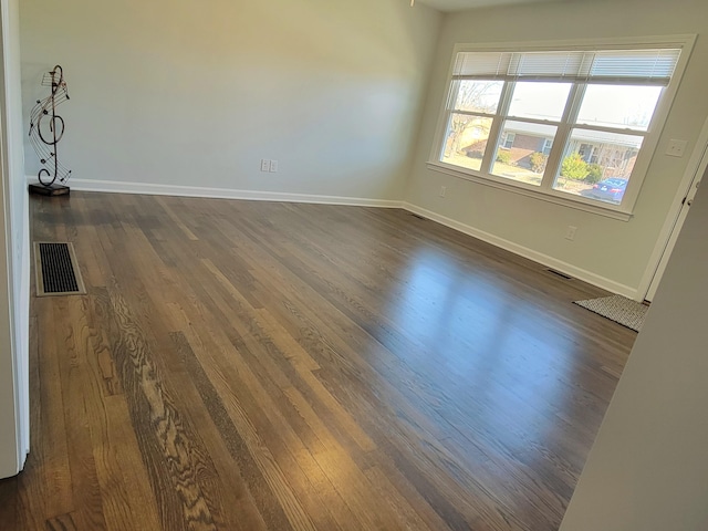 empty room featuring dark hardwood / wood-style flooring