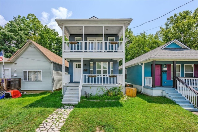 view of front of home featuring a front lawn, a balcony, and covered porch