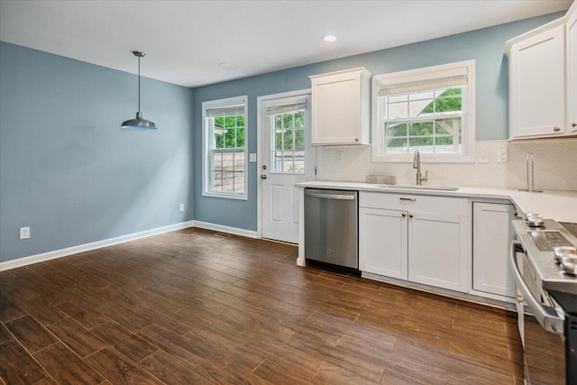 kitchen with sink, tasteful backsplash, appliances with stainless steel finishes, pendant lighting, and white cabinets